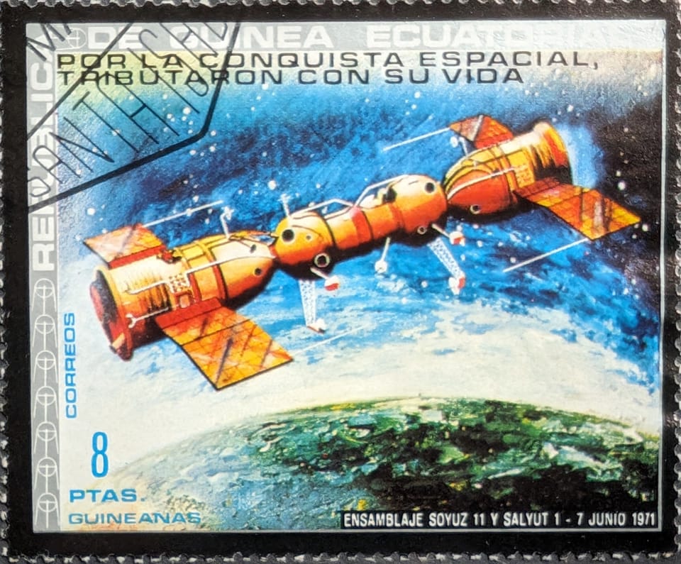 An Equatorial Guinea stamp depicting two Russian spacecraft connected together, orbiting the Earth.