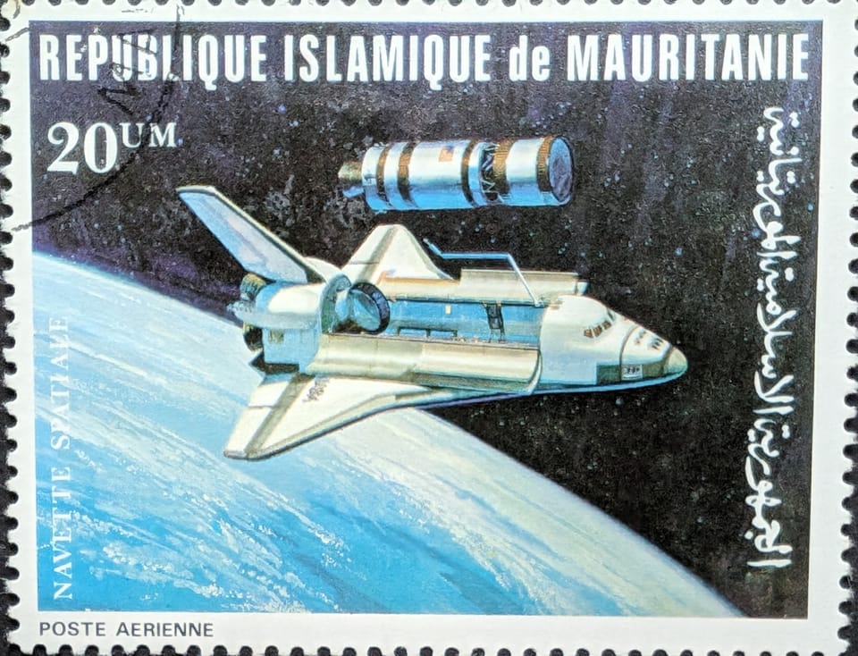 A Mauritanian stamp depicting the Space Shuttle orbiting the Earth. The shuttle is deploying a satellite using a robot arm.